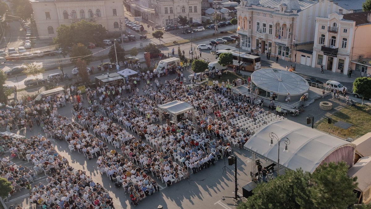 A crowd gathers in an outdoor event.